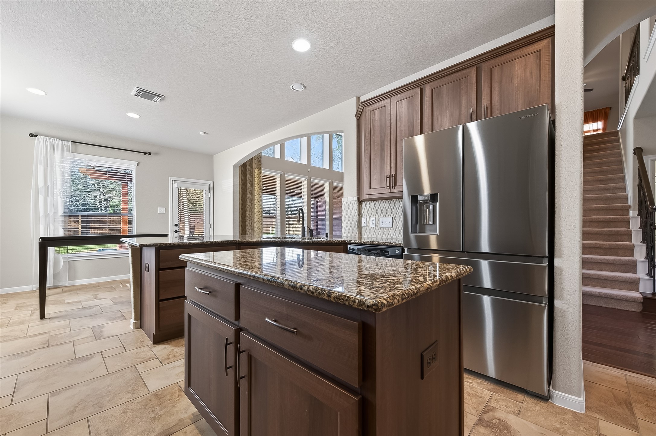 22 North Arrow Canyon Circle Spring, TX 77389 - Photo 10 of 50 a kitchen with stainless steel appliances granite countertop a refrigerator a sink a stove and a refrigerator