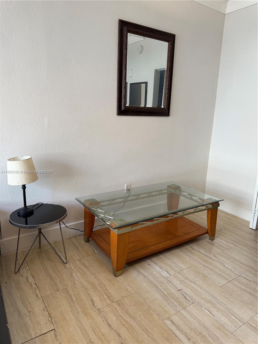 1330 Pennsylvania Avenue, Unit 206 Miami Beach, FL 33139 - Photo 12 of 14 a living room with furniture and a wooden floor