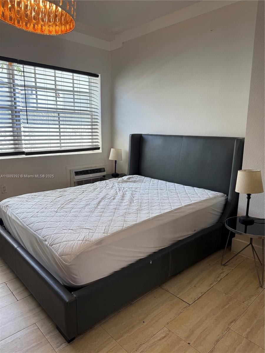 1330 Pennsylvania Avenue, Unit 206 Miami Beach, FL 33139 - Photo 13 of 14 a bed sitting in a bedroom next to a window
