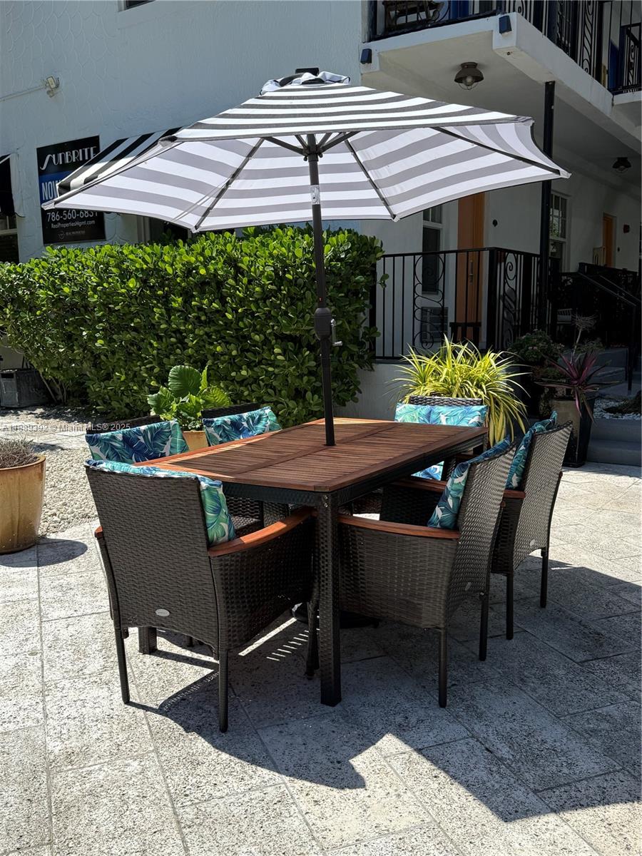 1330 Pennsylvania Avenue, Unit 206 Miami Beach, FL 33139 - Photo 5 of 14 a patio with table and chairs