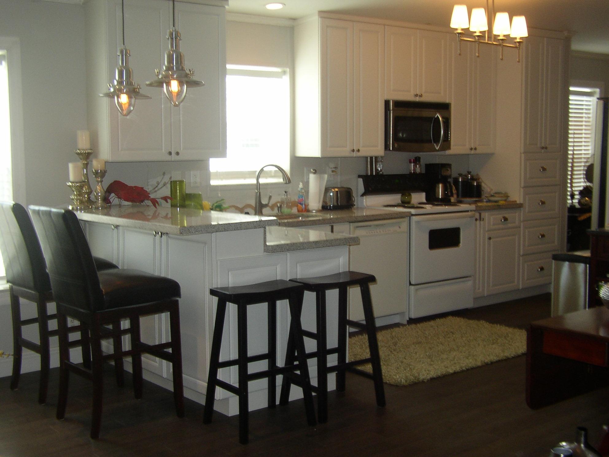 a kitchen with a dining table chairs and microwave