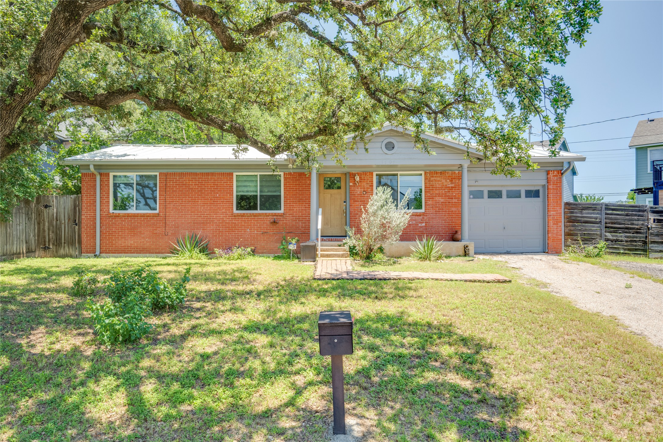 1707 Overhill Drive Austin, TX 78721 - Photo 1 of 36 Mature trees shade this charming brick home with an attached garage.