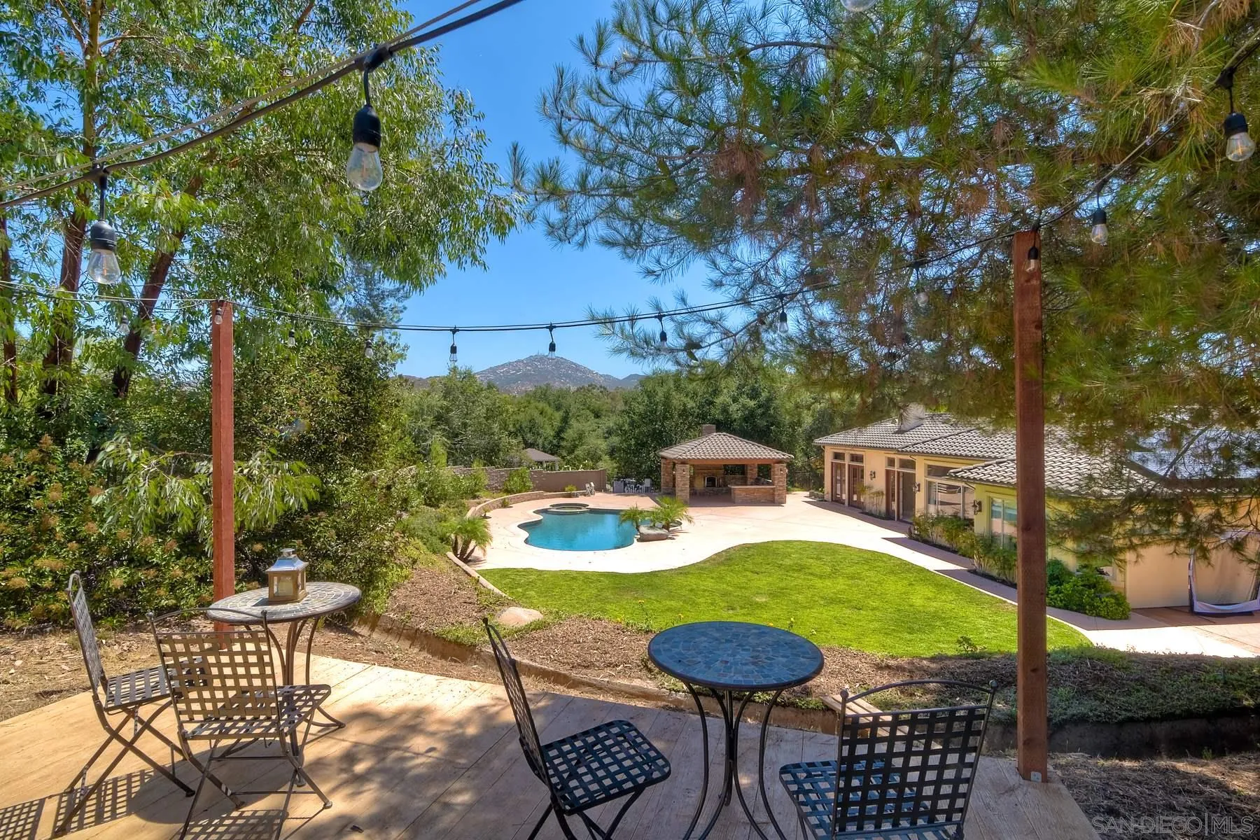 14050 Lake Poway Road Poway, CA 92064 - Photo 24 of 29 a view of a patio with table and chairs potted plants and large tree