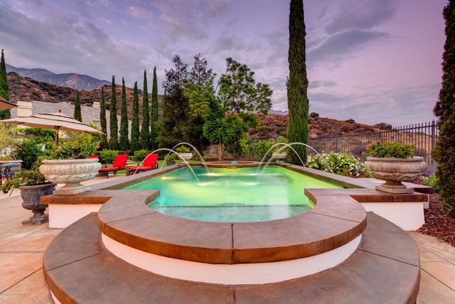 a view of a swimming pool with a yard