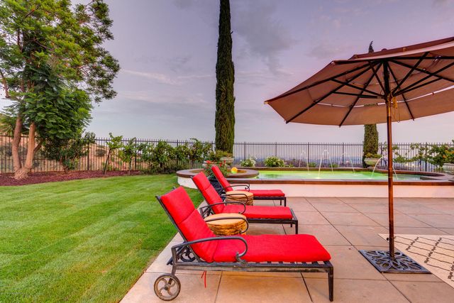 a view of a backyard with sitting area
