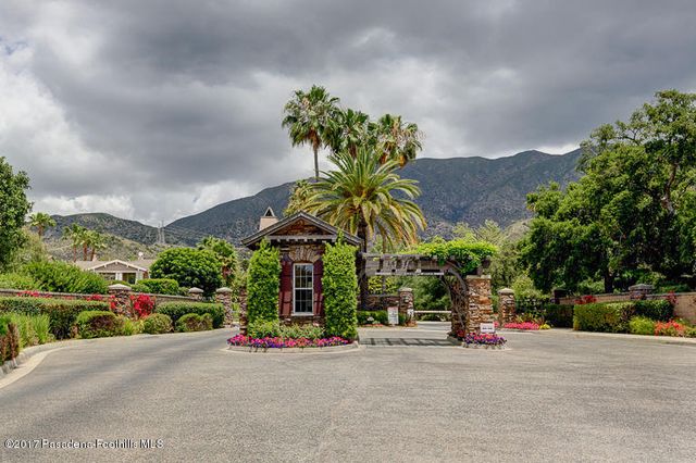 a view of a street with a couple of cars parked in front of it