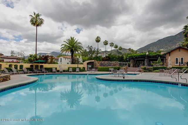 a swimming pool with outdoor seating and yard