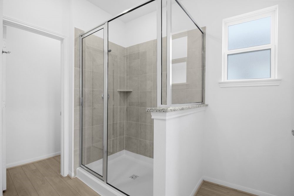 735 Willow Grove Lane Rosenberg, TX 77471 - Photo 13 of 26 a bathroom with a glass shower door