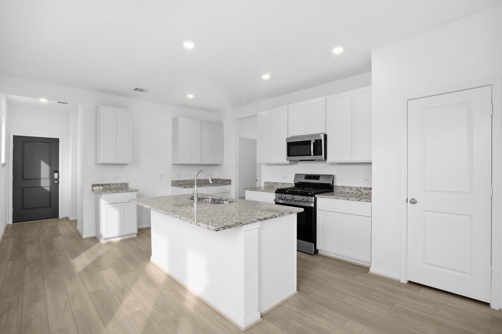 735 Willow Grove Lane Rosenberg, TX 77471 - Photo 2 of 26 a kitchen with a sink stove and refrigerator