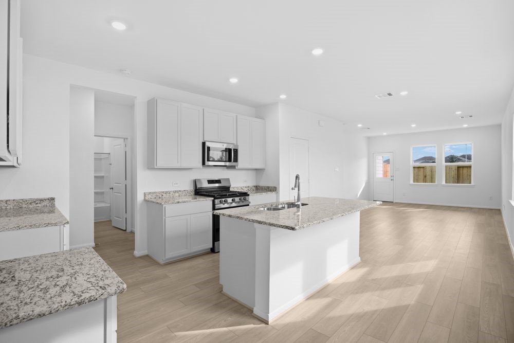 735 Willow Grove Lane Rosenberg, TX 77471 - Photo 3 of 26 a kitchen with stainless steel appliances granite countertop a sink stove and refrigerator