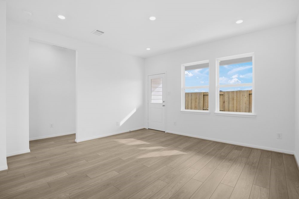 735 Willow Grove Lane Rosenberg, TX 77471 - Photo 6 of 26 an empty room with wooden floor and windows