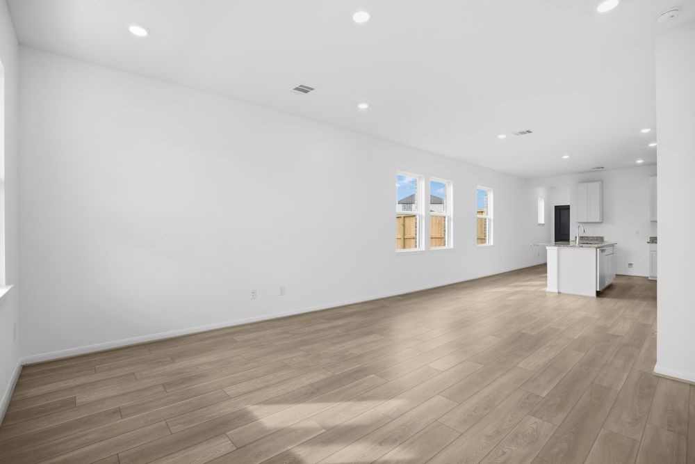 735 Willow Grove Lane Rosenberg, TX 77471 - Photo 7 of 26 a view of empty room with wooden floor and windows