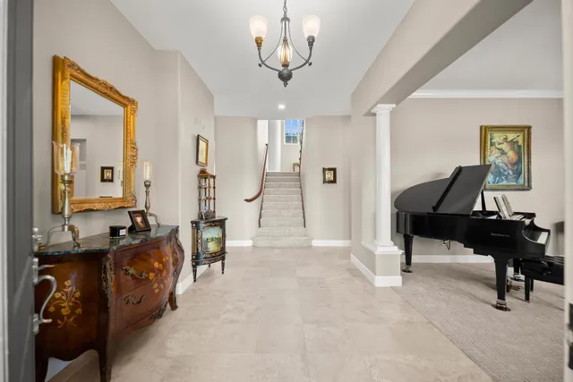 a living room with furniture and a piano