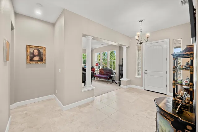 a view of a dining room with furniture and chandelier