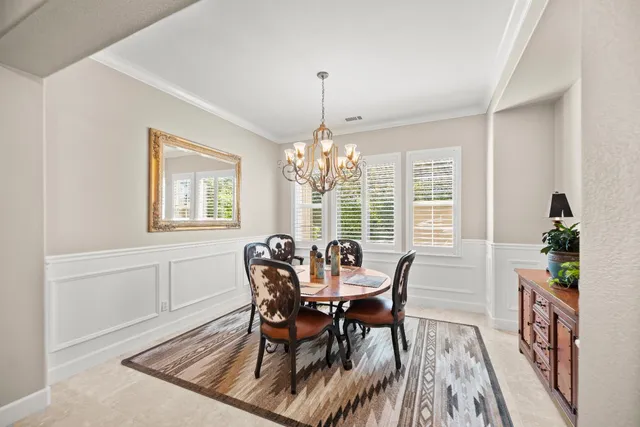 a living room with furniture a rug and a window