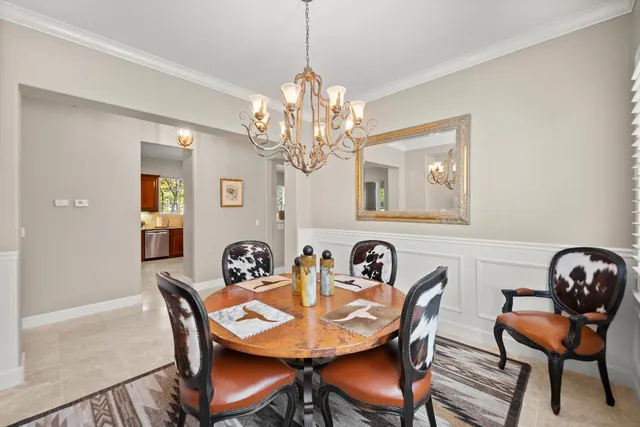 a dining room with furniture a rug and wooden floor