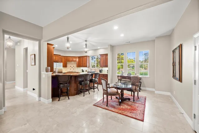 a bedroom with furniture a flat screen tv and a window