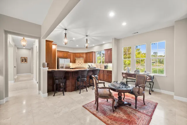 a view of a workspace with furniture and a window