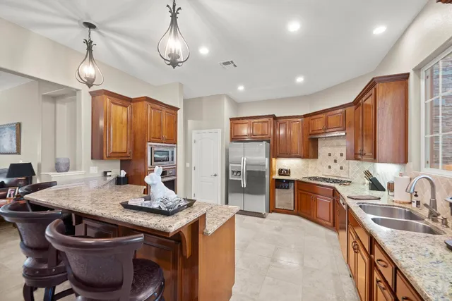 a spacious bedroom with a bed a couch and a flat screen tv