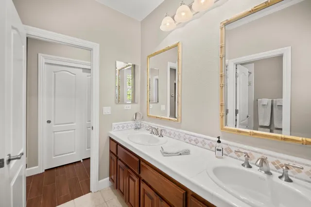 a bathroom with a tub sink toilet and mirror
