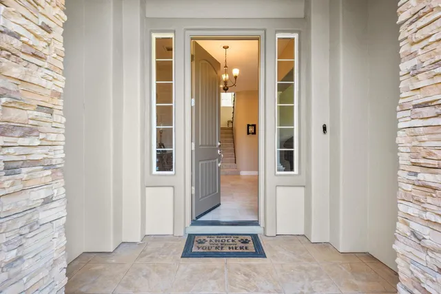 a living room with furniture fireplace and a large window