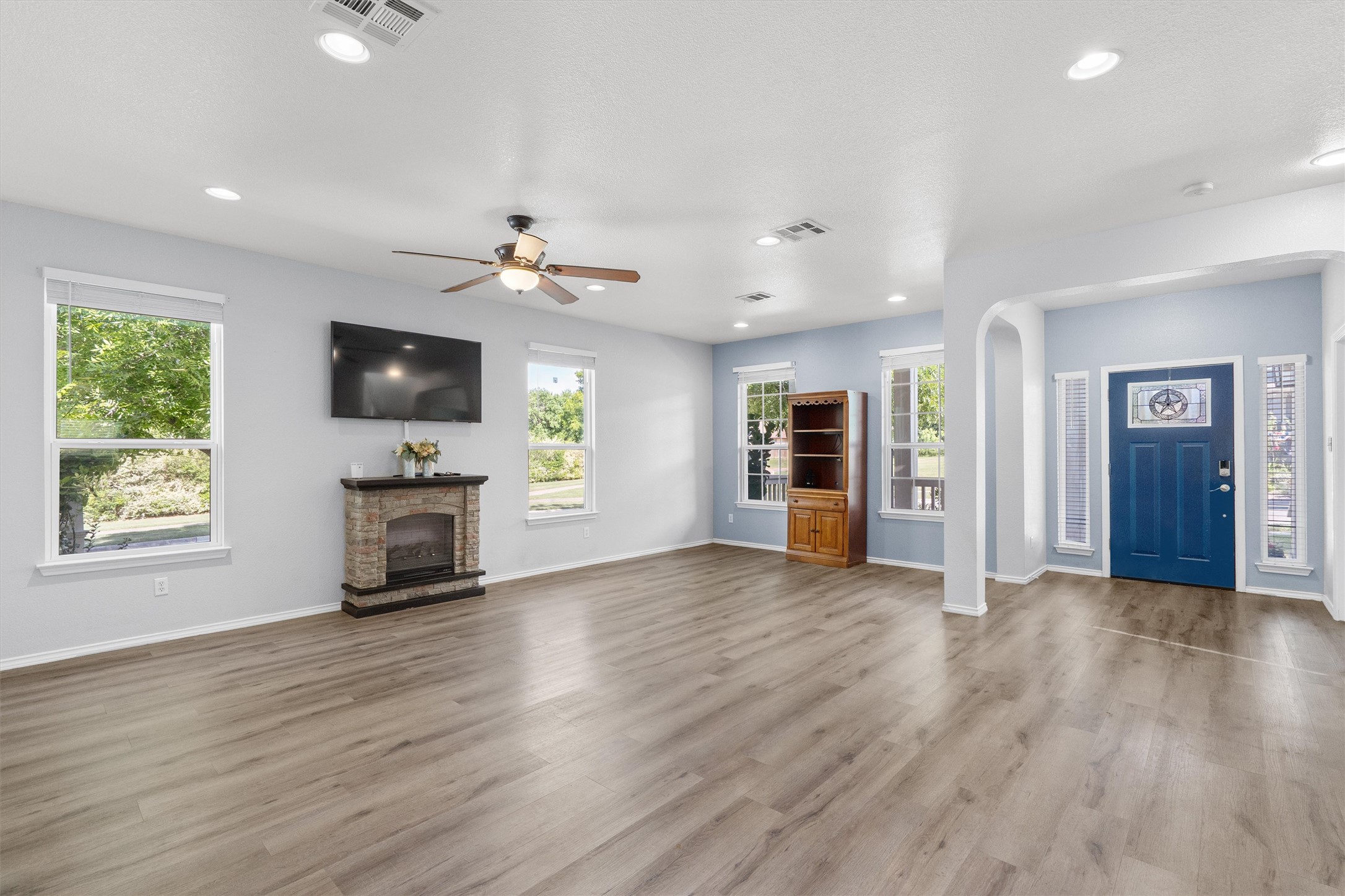 1833 Thompson Trail Round Rock, TX 78664 - Photo 4 of 40 A spacious living area features wide plank flooring and an inviting fireplace.