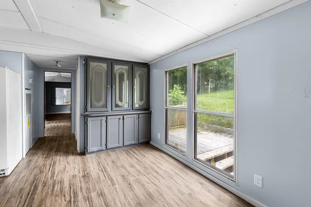 a view of a room with kitchen outdoor space and wooden floor