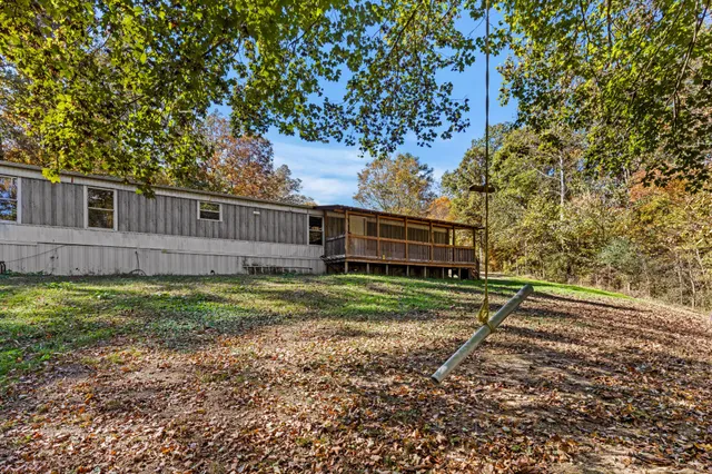 a view of a yard with plants and trees