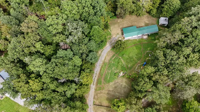 an aerial view of a house with a yard