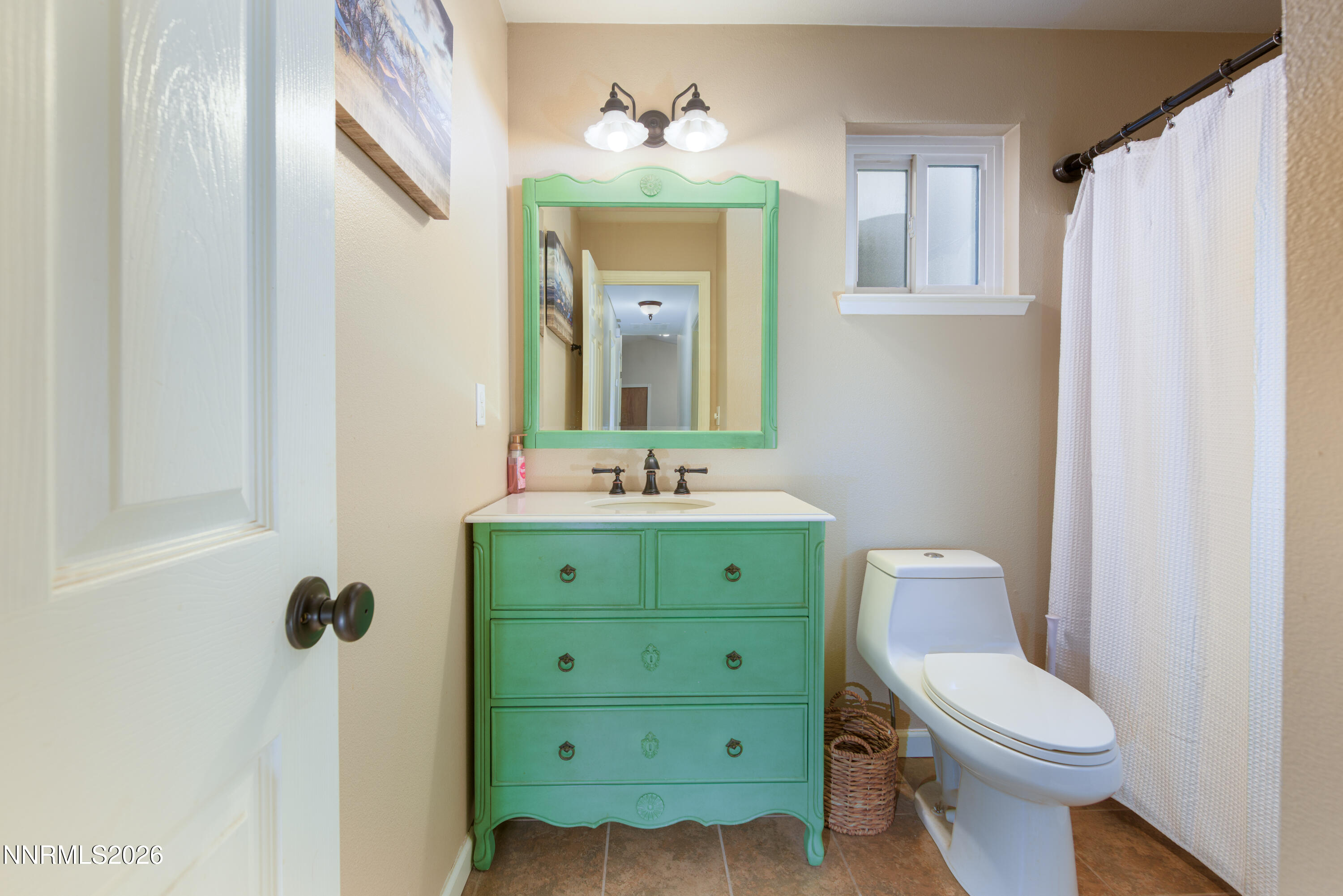 624 Victoria Way Gardnerville, NV 89460 - Photo 13 of 25 a bathroom with a toilet sink and mirror