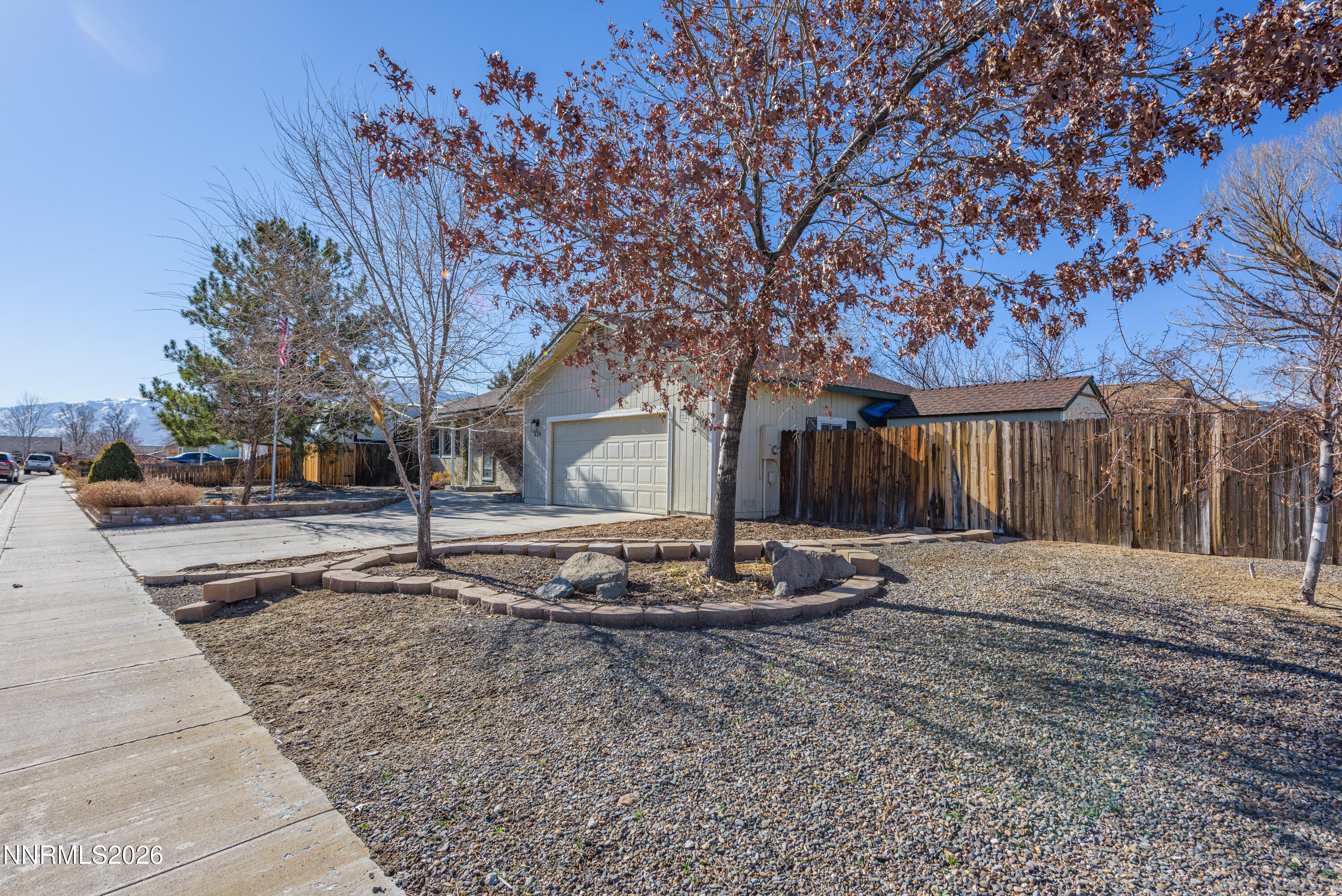 624 Victoria Way Gardnerville, NV 89460 - Photo 19 of 25 a backyard of a house with trees and outdoor seating