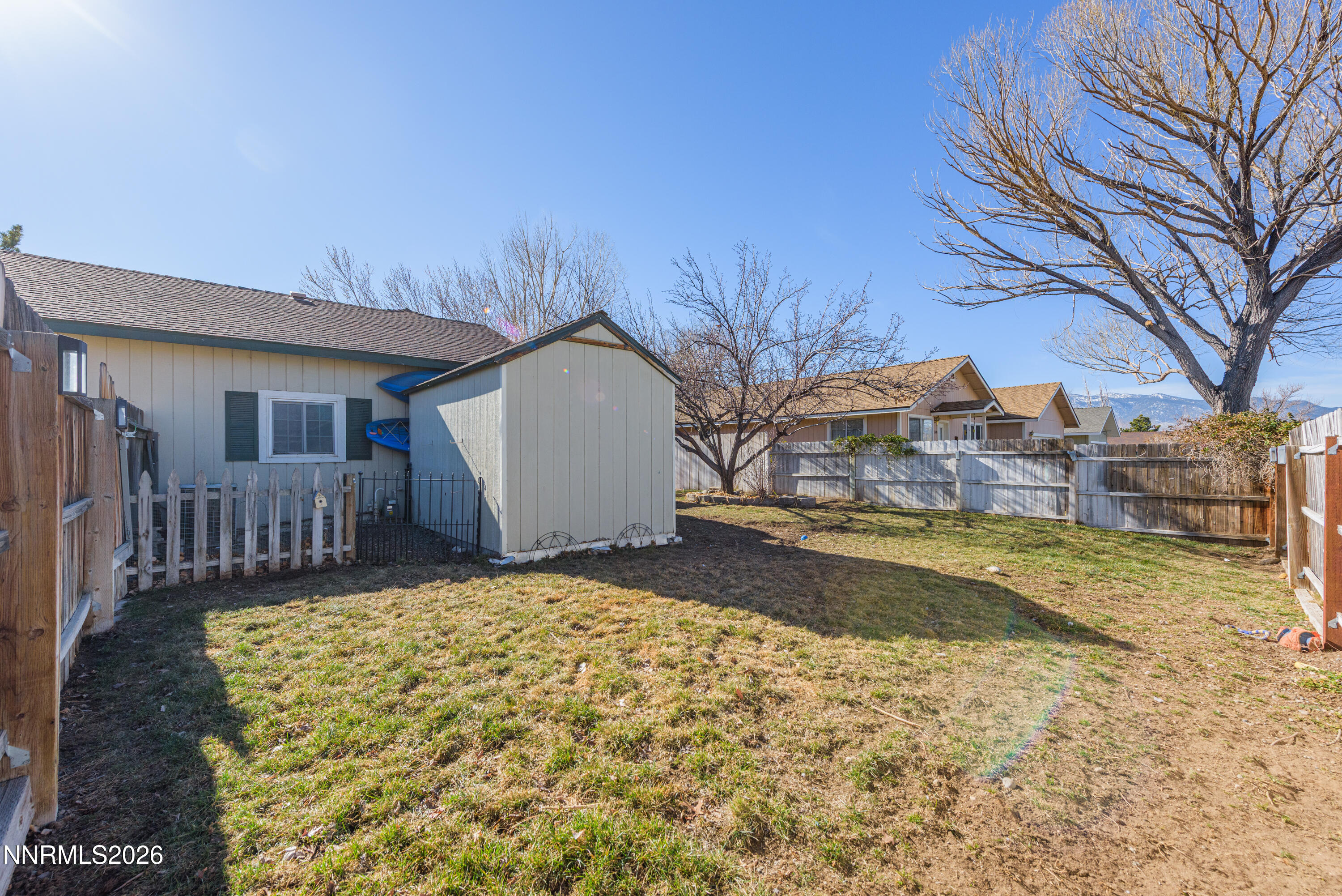624 Victoria Way Gardnerville, NV 89460 - Photo 23 of 25 a view of a house with a yard and fence