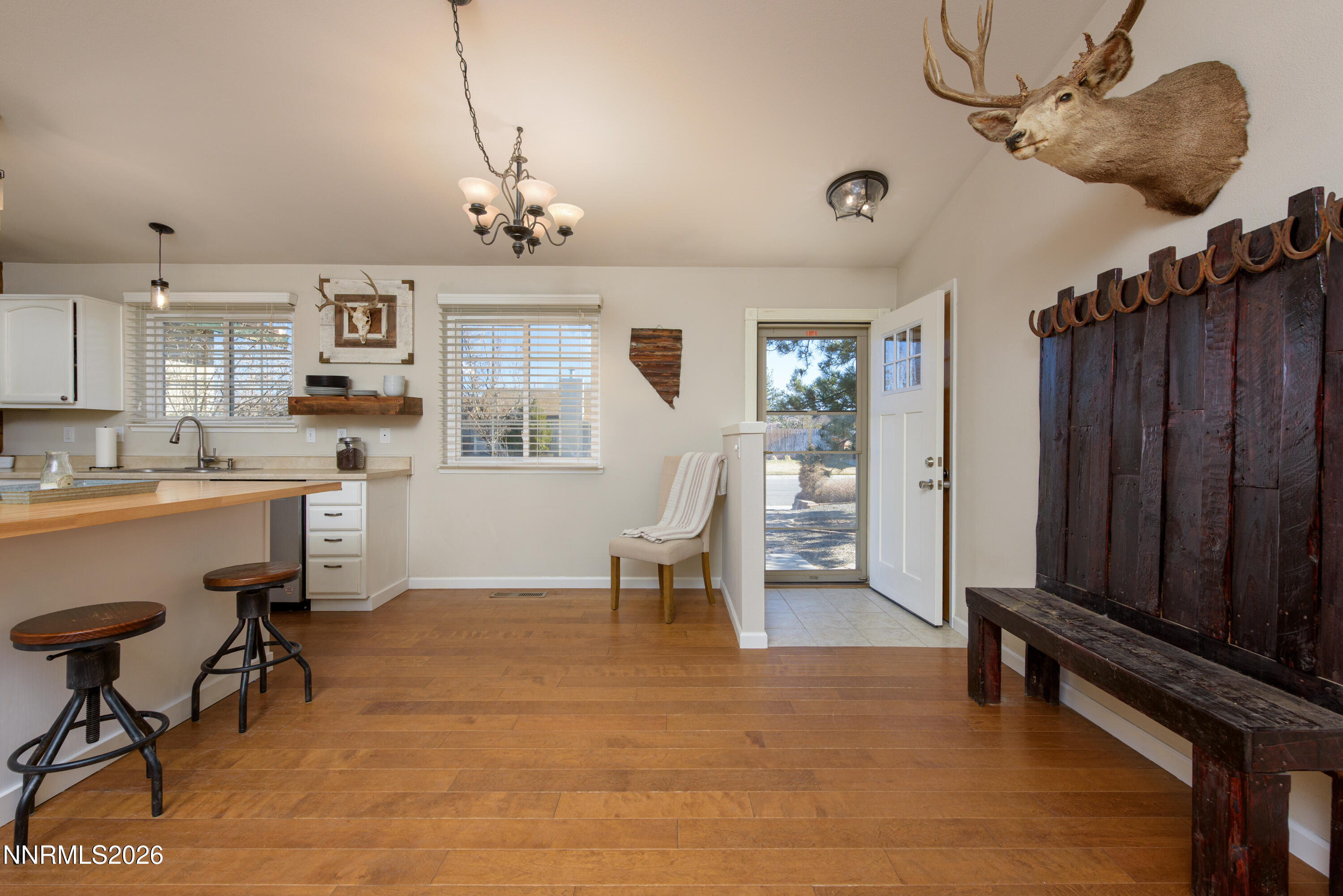 624 Victoria Way Gardnerville, NV 89460 - Photo 7 of 25 a living room with furniture a dining table and paintings on the wall