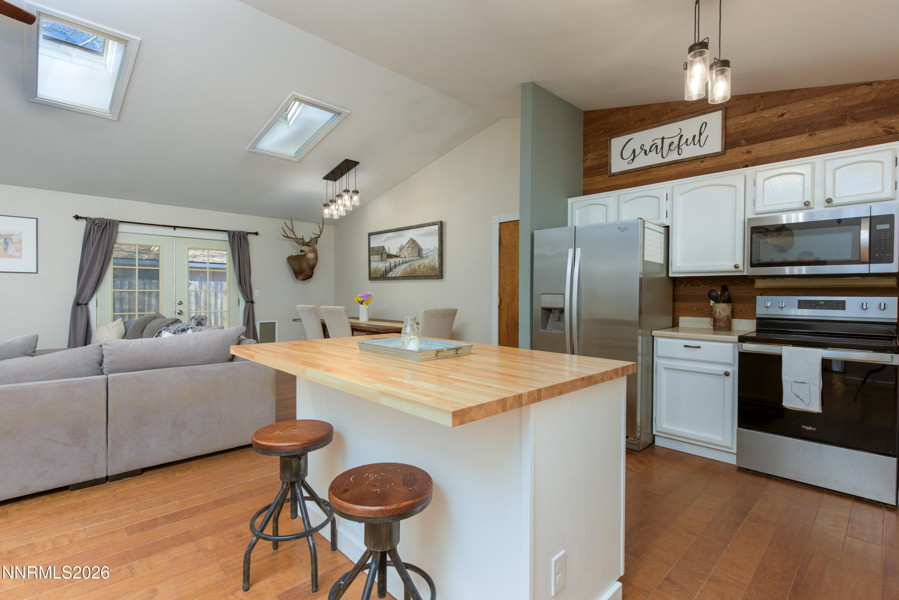 624 Victoria Way Gardnerville, NV 89460 - Photo 8 of 25 a kitchen with stainless steel appliances kitchen island granite countertop a sink and a refrigerator