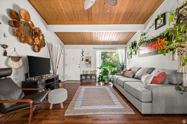 909 Rancho Boulevard Ogden, UT 84404 - Photo 3 of 27 Spacious living area featuring wood-finish flooring, a wood-paneled vaulted ceiling, and ample natural light through a large window