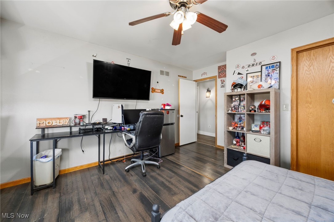 11827 Stratton Road West Salem, OH 44287 - Photo 39 of 47 Bedroom featuring a desk, dark wood-style floors, ceiling fan, and freestanding refrigerator