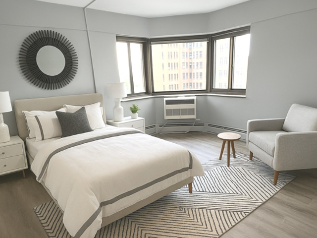 7337 South South Shore Drive, Unit 904 Chicago, IL 60649 - Photo 6 of 15 a bedroom with a bed and a window