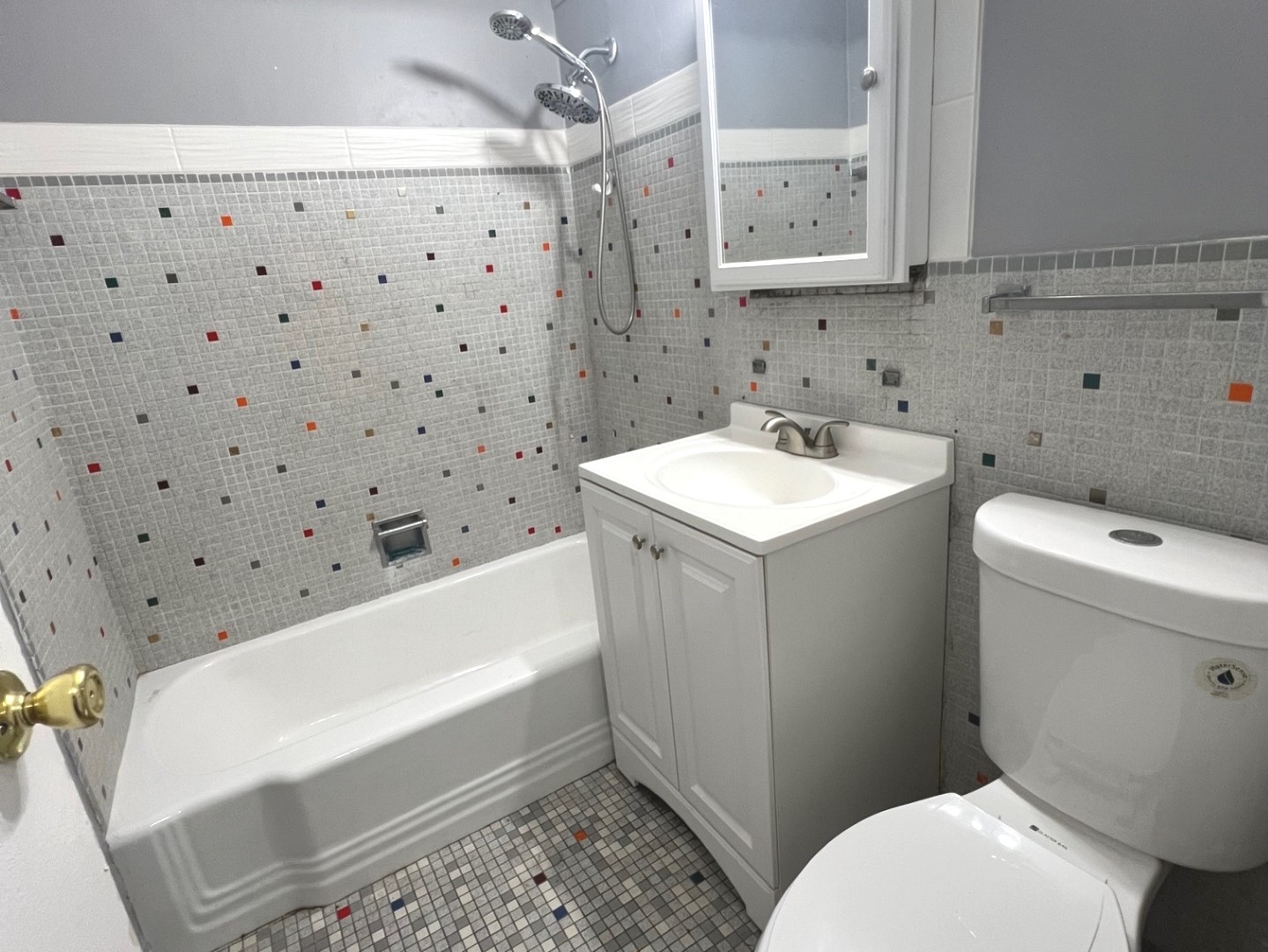 7337 South South Shore Drive, Unit 904 Chicago, IL 60649 - Photo 8 of 15 a bathroom with a sink toilet vanity and bathtub