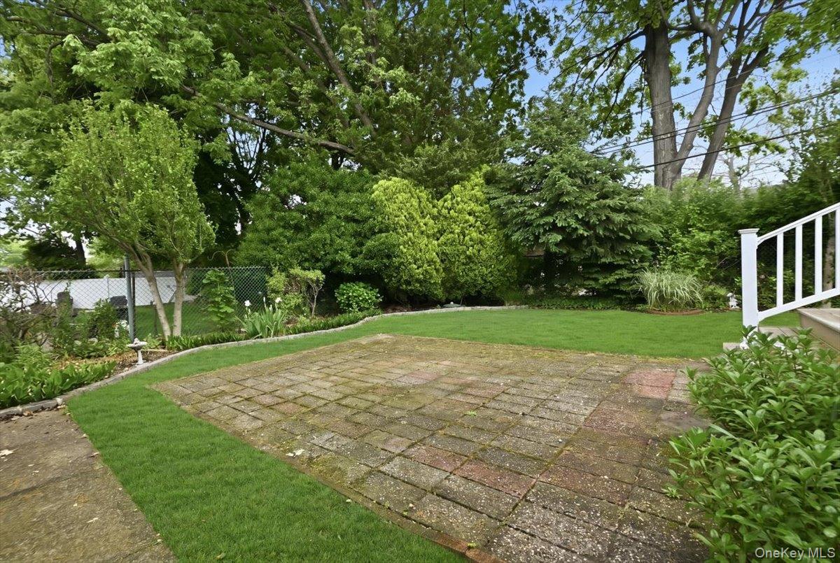 17 Avon Road Farmingdale, NY 11735 - Photo 36 of 46 a view of a yard with plants and trees