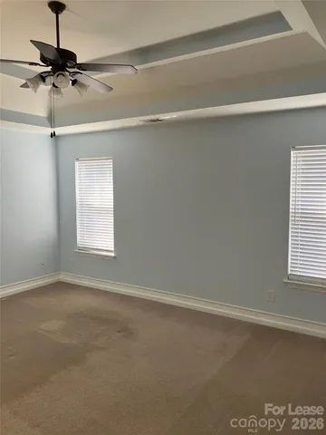 a bathroom with a granite countertop sink a toilet and a mirror