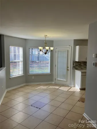 a kitchen with a stove top oven and cabinets