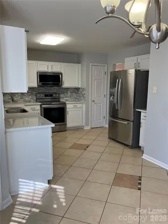 an empty room with a empty space and windows