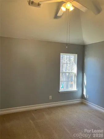 a view of a room with a window and a ceiling fan
