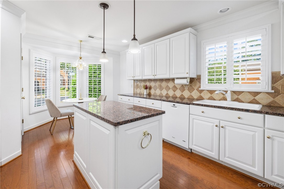 5000 Park Commons Loop Glen Allen, VA 23059 - Photo 5 of 32 a kitchen with granite countertop a sink and white cabinets with wooden floor