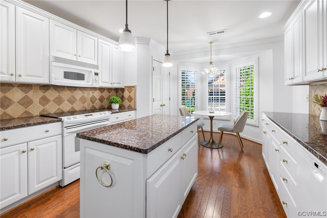 5000 Park Commons Loop Glen Allen, VA 23059 - Photo 7 of 32 a kitchen with stainless steel appliances granite countertop a stove a sink dishwasher and white cabinets with wooden floor
