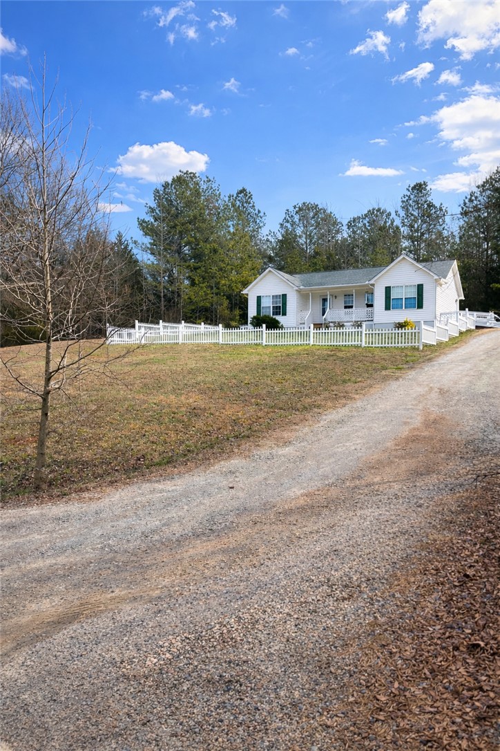 736 Rodgers Road Seneca, SC 29678 - Photo 2 of 7 This charming home features a classic white picket fence and a welcoming front porch.
