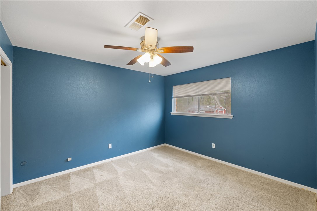 29 Dogwood Road Huntsville, TX 77320 - Photo 19 of 39 Unfurnished room featuring carpet floors and ceiling fan