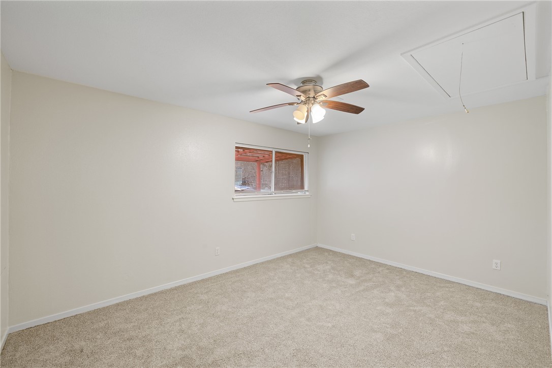 29 Dogwood Road Huntsville, TX 77320 - Photo 20 of 39 Empty room with attic access, light colored carpet, and a ceiling fan