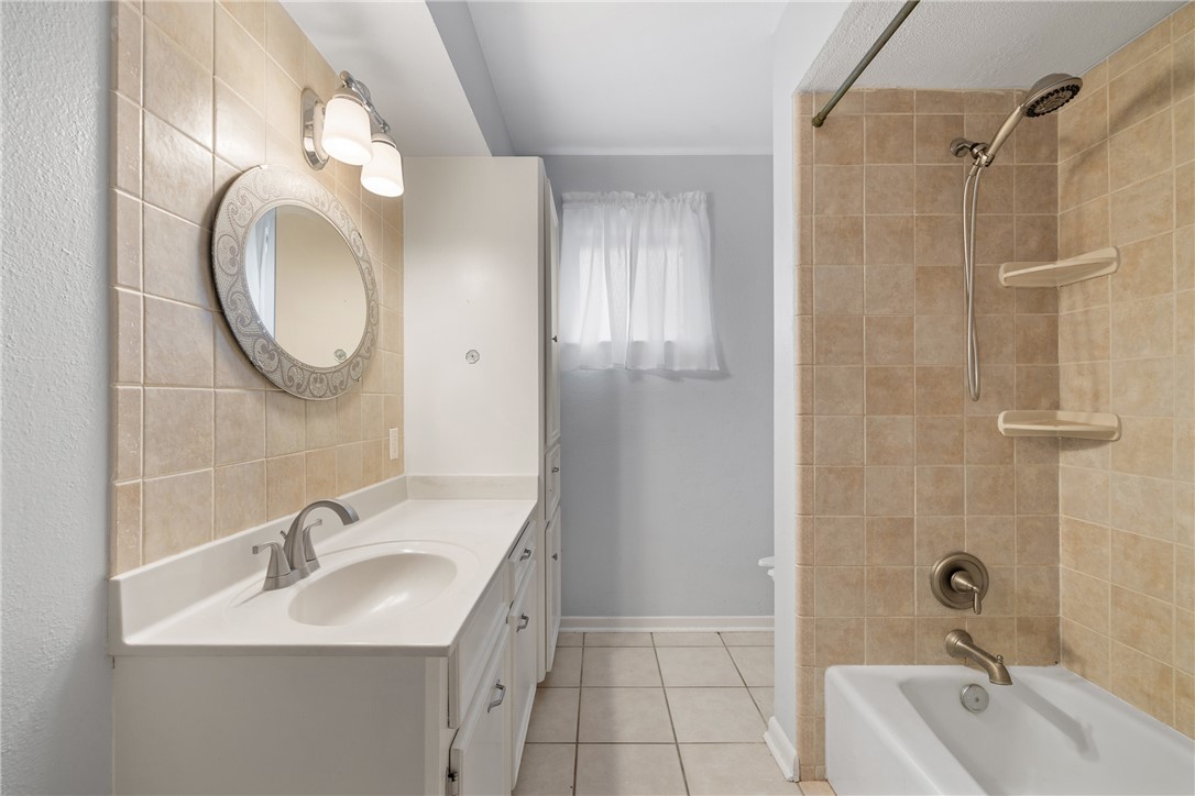 29 Dogwood Road Huntsville, TX 77320 - Photo 21 of 39 Bathroom with light tile patterned floors, bathing tub / shower combination, and vanity