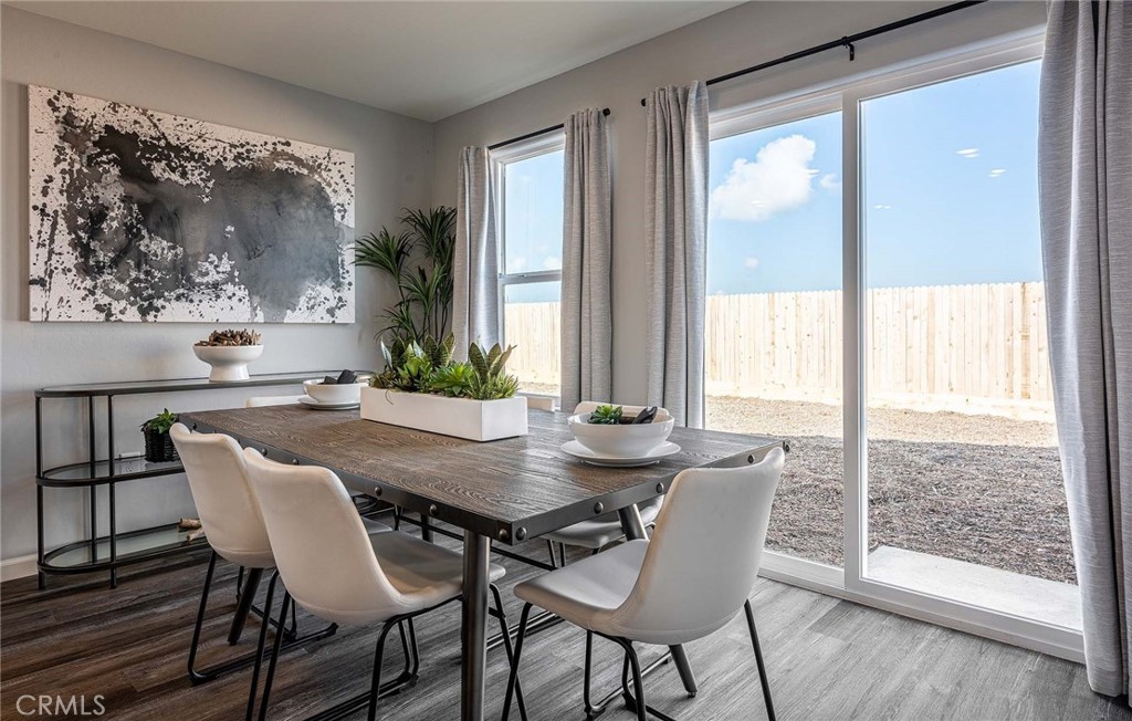 4735 Jema Way, Unit 9 B1 Merced, CA 95348 - Photo 7 of 19 a view of a dining room with furniture wooden floor and a large window